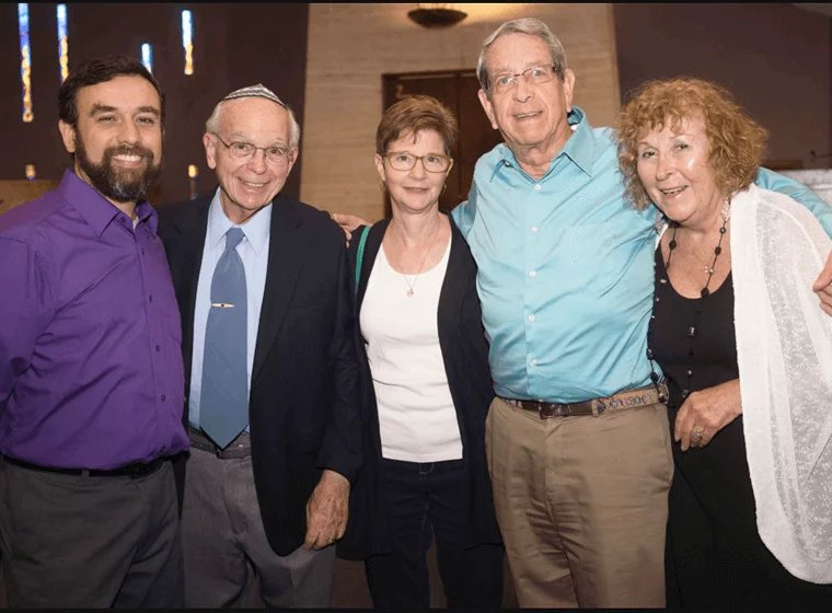 multi generational group of adults posing at social event